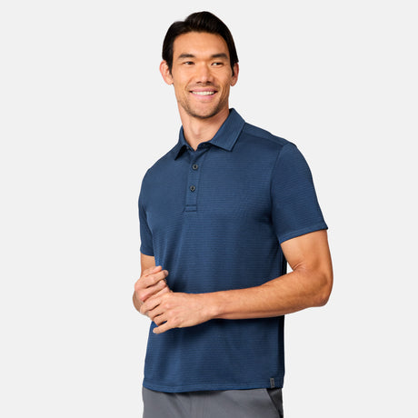 [Scott is 6’3" wearing size M] Man wearing a blue polo shirt against a white background