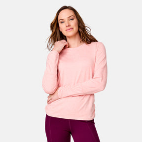 [Emily is 5’9” wearing a size Small.] Woman wearing Free Country Women's Cloud Knit Crew Neck Top in Carnation, size S, made from Breathable stretch performance fabric featuring a sueded finish and soft hand feel, styled with pink leggings