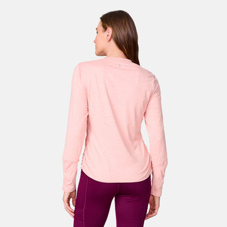 [Emily is 5’9” wearing a size Small.] Woman wearing Free Country Women's Cloud Knit Crew Neck Top in Carnation, size S, made from Breathable stretch performance fabric featuring a sueded finish and soft hand feel, styled with pink leggings