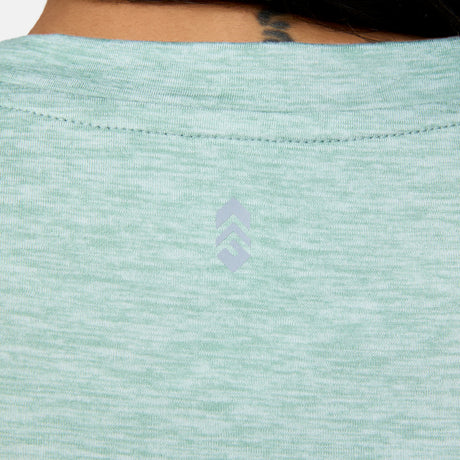 [Angelique is 5’10" wearing a size Small.] Woman wearing Free Country Women's Cloud Knit Crew Neck Top in Green Tea, size S, made from Breathable stretch performance fabric featuring a sueded finish and soft hand feel, styled with blue leggings