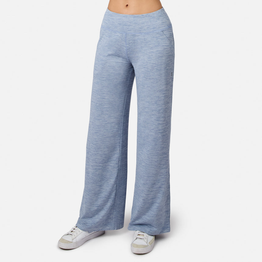 Woman in dusk Women’s Cloud Knit Wide Leg Pants by Free Country and white sneakers, standing against a plain white backdrop. The cropped photo emphasizes the comfy pants and stylish shoes.