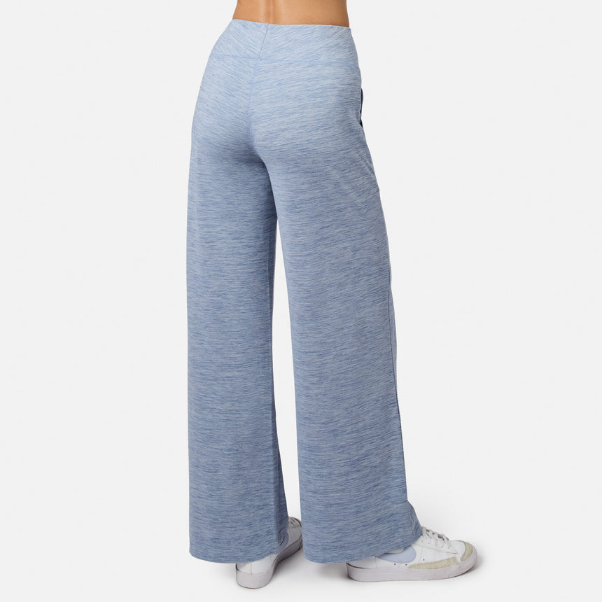 Person wearing Free Country Women’s Cloud Knit Wide Leg Pants in light blue with white sneakers, viewed from the back against a plain white background.