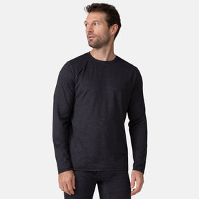 A man with short brown hair and a beard wears the Clearance Men's Cloud Knit Base Layer Top in a dark color and matching pants, featuring moisture-wicking fabric, as he stands against a plain light gray background looking off to the side.