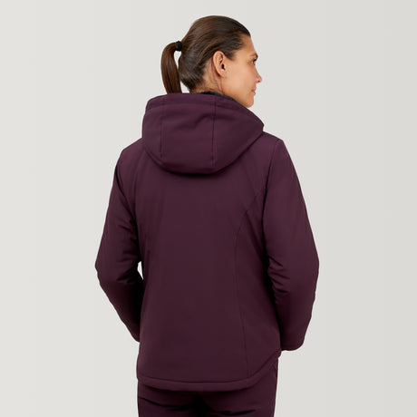 A person with brown hair in a ponytail is wearing the Clearance Women's Thermo Super Softshell® Ski Jacket, facing away from the camera against a plain light background.