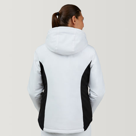 A woman with brown hair in a ponytail faces away, wearing the Clearance Women's Thermo Super Softshell® Ski Jacket in white with black side panels. The plain background is light-colored.