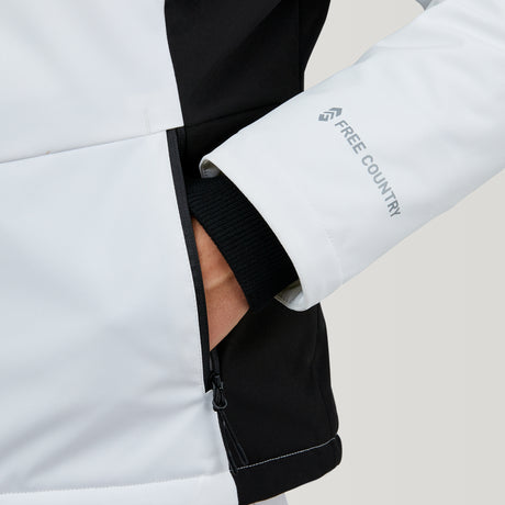 A person in a white and black Clearance Women's Thermo Super Softshell® Ski Jacket with water-resistant fabric has their hand in the zippered pocket.