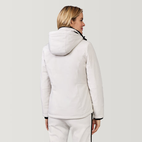 [Model is wearing a size Small.] Woman wearing Free Country Women's FreeCycle® Thermo Super Softshell® II Jacket in white with a full front zipper opening, lower pockets, soft lining, a detachable hood with an adjustable drawcord, and water resistant and wind resistant stretch performance fabric, light grey background. Best women’s jacket for winter weather.