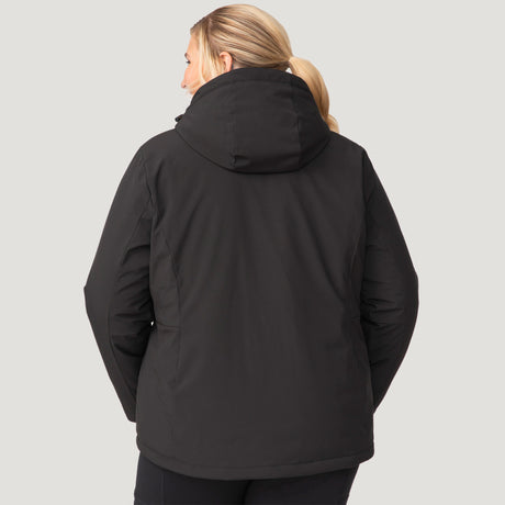 [Lola is 5'10.5" wearing a size 1X.] Woman wearing Free Country Women's Plus Size FreeCycle® Thermo Super Softshell® II Jacket in black with a full front zipper opening, lower pockets, soft lining, a detachable hood with an adjustable drawcord, and water resistant and wind resistant stretch performance fabric, light grey background. Best women’s jacket for winter weather.