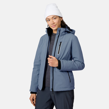 Woman in a light blue FreeCycle Thermo Softshell II jacket with hood and zippered pockets.