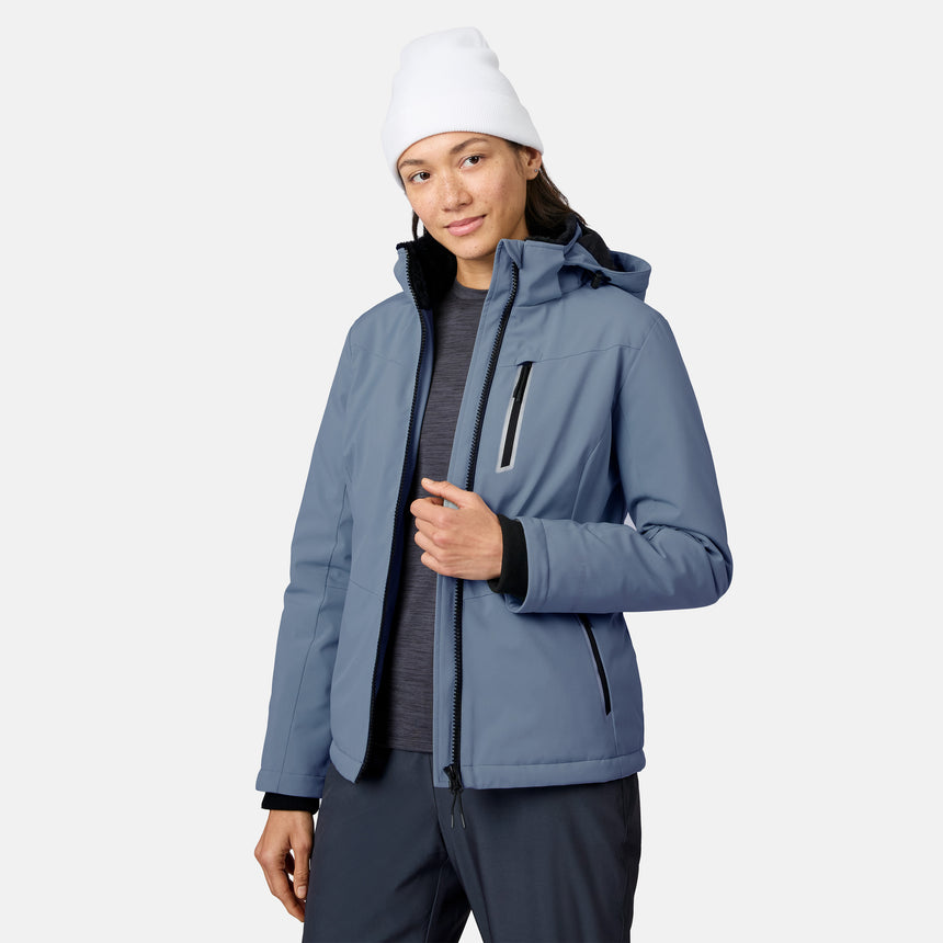 Woman in a light blue FreeCycle Thermo Softshell II jacket with hood and zippered pockets.