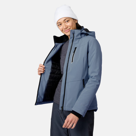 Female model wearing a blue FreeCycle Thermo Softshell II Jacket with black interior lining and a white knit beanie.