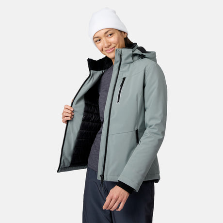 Side view of model in light gray FreeCycle Thermo Softshell II jacket with hood and white beanie.