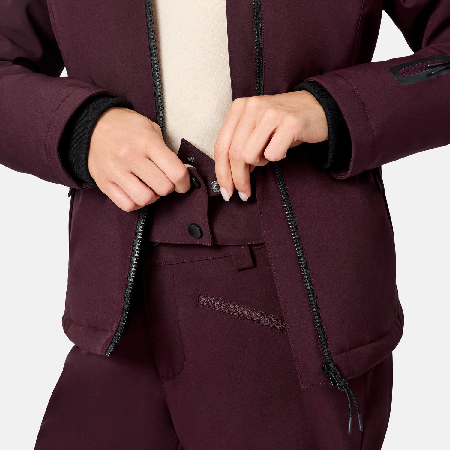 [Model is wearing size S.] Close up of burgundy Women's Thermo Super Softshell jacket showing front zipper snap closure and cuff detail.