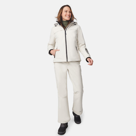 [Model is wearing size S.] Full-body shot of a woman in cream Thermo Super Softshell Lined Jacket and matching pants with zipper details