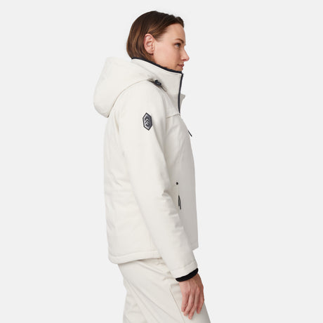 [Model is wearing size S.] Side view of the white Thermo Super Softshell jacket with a dark logo patch on the sleeve