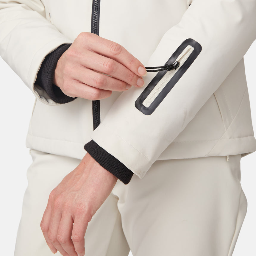 [Model is wearing size S.] Close-up of a hand pulling the zipper on a white Thermo Super Softshell jacket