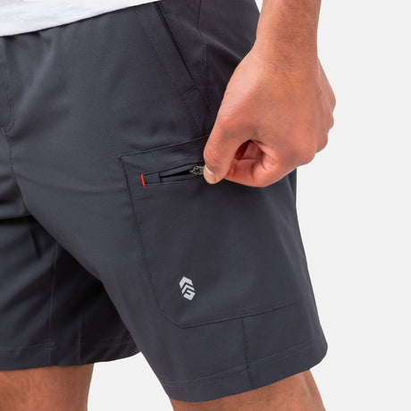 [Model is wearing a size Medium.] Man wearing Free Country Men's Tech Stretch Short II in Charcoal, size M, made from moisture wicking stretch performance fabric featuring an elastic waistband with a drawcord and a side slant pockets, styled with a white t shirt #color_charcoal