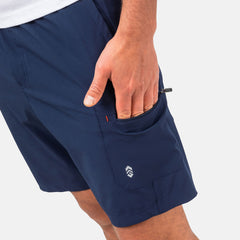 [Model is wearing a size Medium.] Man wearing Free Country Men's Tech Stretch Short II in Slate, size M, made from moisture wicking stretch performance fabric featuring an elastic waistband with a drawcord and a side slant pockets, styled with a white t shirt #color_slate