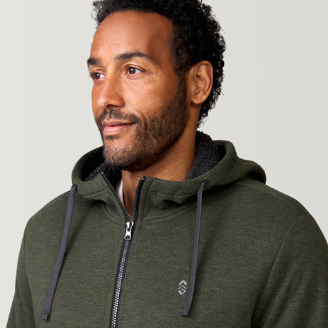 [Jonathan is 6'1” wearing a size Medium.] Free Country Everybody Hoodies in dark green, featuring soft melange fabric, moisture-wicking properties, and black drawstrings, styled with casual T-shirts and dark pants.