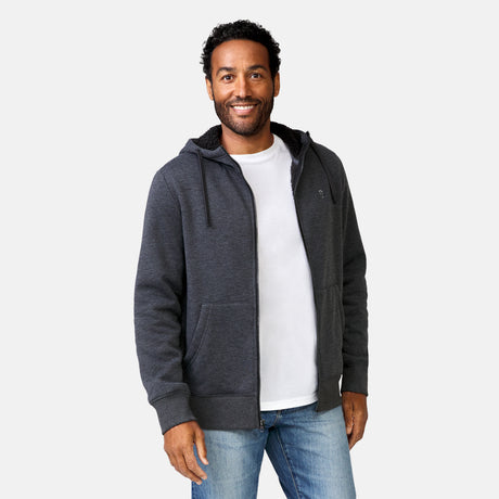 [Jonathan is 6'1” wearing a size Medium.] Free Country Everybody Hoodies in dark grey, featuring soft melange fabric, moisture-wicking properties, and black drawstrings, styled with casual T-shirts and dark pants.