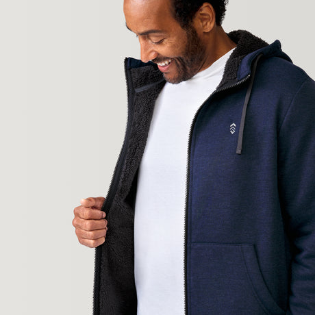 [Jonathan is 6'1” wearing a size Medium.] Free Country Everybody Hoodies in navy, featuring soft melange fabric, moisture-wicking properties, and black drawstrings, styled with casual T-shirts and dark pants.