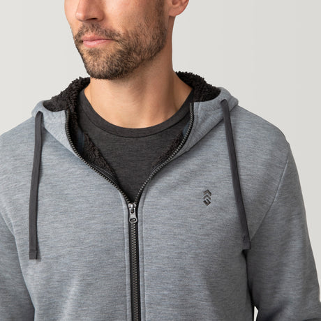 [Matt is 6'2" wearing a size Medium.] Free Country Everybody Hoodies in gray, featuring soft melange fabric, moisture-wicking properties, and black drawstrings, styled with casual T-shirts and dark pants.