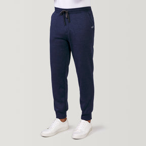 [Model is 6'1" wearing a size Medium.] Man wearing Free Country Men's Sherpa Lined Jogger in dark navy with a drawcord waistband, soft lining, and side pockets, light grey background. Perfect men’s pants for fall weather.
