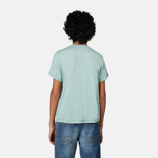 A person with curly hair, seen from the back against a plain white background, is wearing a light green Boys' Microtech® Graphic Crew Neck Shirt from Free Country and blue jeans. The shirt’s moisture-wicking properties and UPF 50+ protection provide comfort and functionality throughout the day.