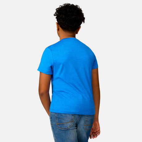 [Model is wearing a size Medium.] Boy wearing the Free Country Boys' Microtech® Graphic Crew Neck Shirt in Royal, size M, featuring lightweight odor free fabric and upf protection, paired with blue jeans #color_ royal