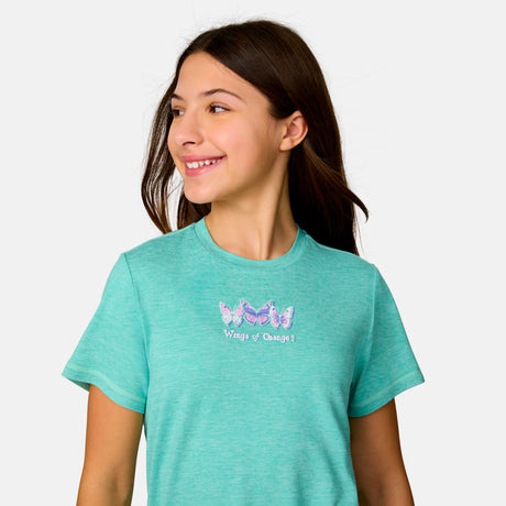 [Model is wearing a size Medium.] Girl wearing the Free Country Girls’ Microtech® Graphic Crew Neck Shirt in Seafoam, size M, featuring lightweight odor free fabric and upf protection, paired with blue jeans #color_ seafoam