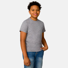 [Model is wearing a size Medium.] Boy wearing the Free Country Boys' Microtech® Crew Neck Shirt in Rock, size M, featuring lightweight odor free fabric and upf protection, paired with blue jeans #color_ rock