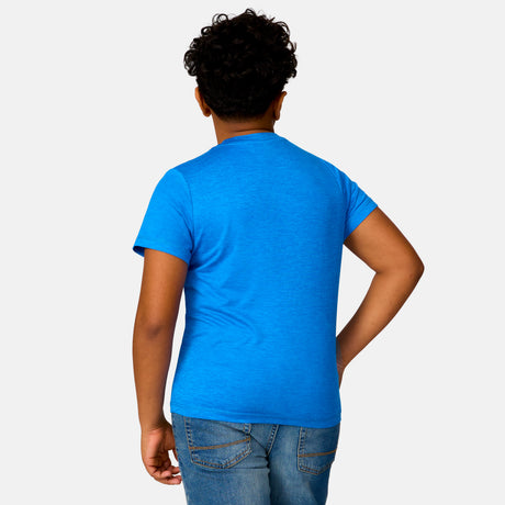 [Model is wearing a size Medium.] Boy wearing the Free Country Boys' Microtech® Crew Neck Shirt in Royal, size M, featuring lightweight odor free fabric and upf protection, paired with blue jeans #color_ royal