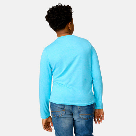 [Model is wearing a size Medium.] Boy wearing the Free Country Boys' Microtech® Long Sleeve Shirt in Aqua, size M, featuring lightweight odor free fabric and upf protection, paired with blue jeans #color_ aqua
