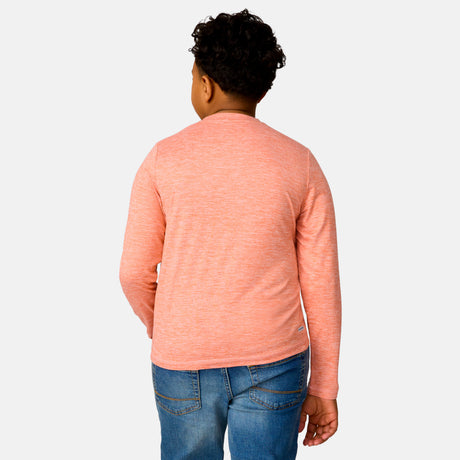 [Model is wearing a size Medium.] Boy wearing the Free Country Boys' Microtech® Long Sleeve Shirt in Sunrise, size M, featuring lightweight odor free fabric and upf protection, paired with blue jeans #color_ sunrise