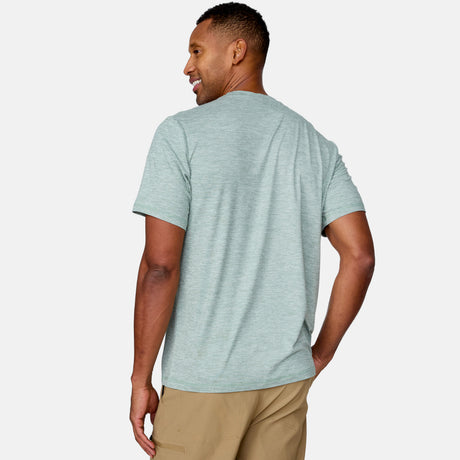 [Anderson is 6'2" wearing a size Medium.] Man wearing Free Country Men's Super Soft Short Sleeve Crew Tee - 2 Pack in Basil, size M, made from anti-odor, breathable lightweight performance fabric featuring a classic active fit, an outdoor traveler design, and a peached finish #color_basil
