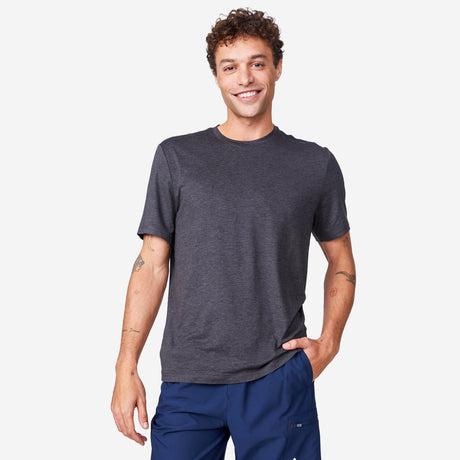 [Miguel is 6'2" wearing a size Medium.] Man wearing Free Country Men's Super Soft Short Sleeve Crew Tee - 2 Pack in Black, size M, made from anti-odor, breathable lightweight performance fabric featuring a classic active fit and a peached finish #color_black