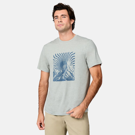 [Jacob is 6’1.5" wearing size M] Man wearing a light gray t-shirt with a blue graphic design on a white background