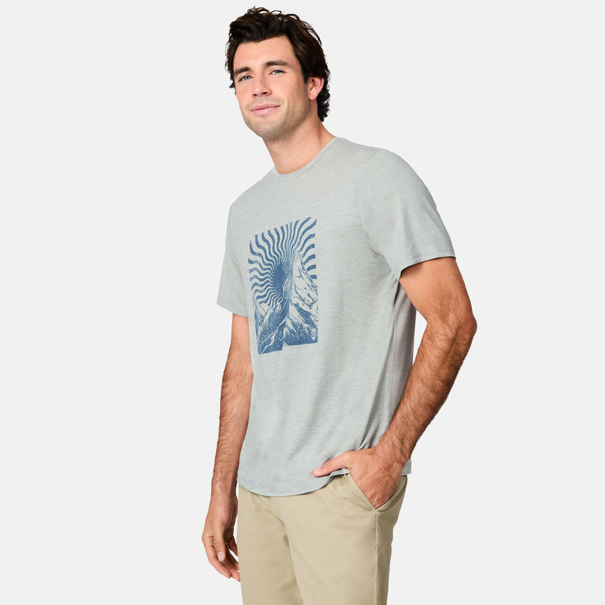 [Jacob is 6’1.5" wearing size M] Man wearing a light gray t-shirt with a blue graphic design on a white background