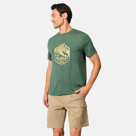 [Scott is 6’3" wearing size M] Man wearing a green t-shirt with a logo and beige shorts on a white background