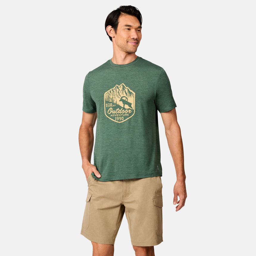 [Scott is 6’3" wearing size M] Man wearing a green t-shirt with a logo and beige shorts on a white background