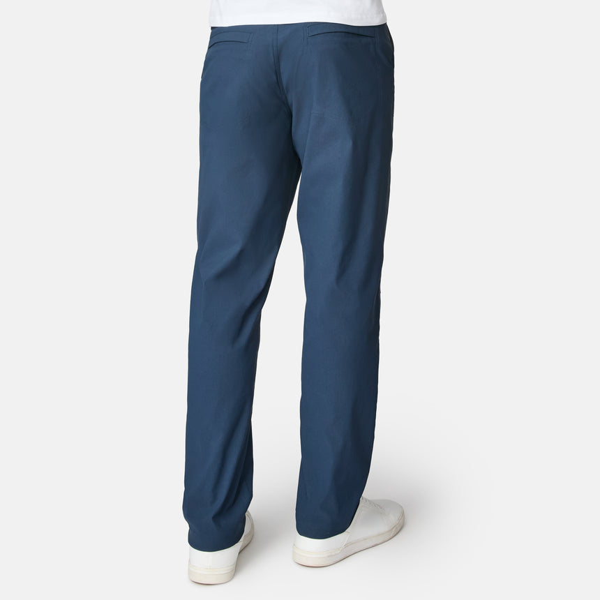Blue pants worn by a person on a white background