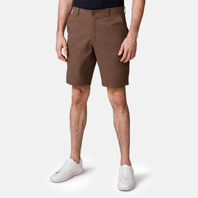 [Model is wearing a size Medium.] Man wearing Free Country Men's Nylon Stretch Casual Short in Saddle, size M, made from lightweight stretch performance fabric featuring a water repellent finish, slanted side pockets, and side leg zippered coin pocket #color_saddle