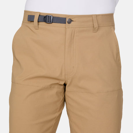 A close-up of a person wearing Free Country Men's Nylon Stretch Trek Short with an adjustable waist belt, shown from waist to upper legs against a plain white background.