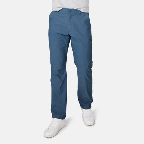 [Miguel is 6'2" wearing a size Medium.] Man wearing Free Country Men's Nylon Stretch Casual Pant in Seal, size M, made from comfortable stretch performance fabric featuring a water repellent finish, articulated knee, coin pocket, and gusset at crotch, styled with a white t shirt and white shoes #color_seal
