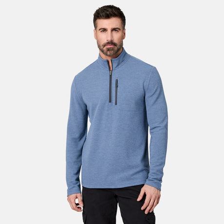 A man with dark hair and a beard wears the Men’s Altitude Quilt 1/2 Zip Mock Neck Shirt by Free Country in Ocean Heather, which features 4-way stretch and a chest pocket, standing against a plain white background.