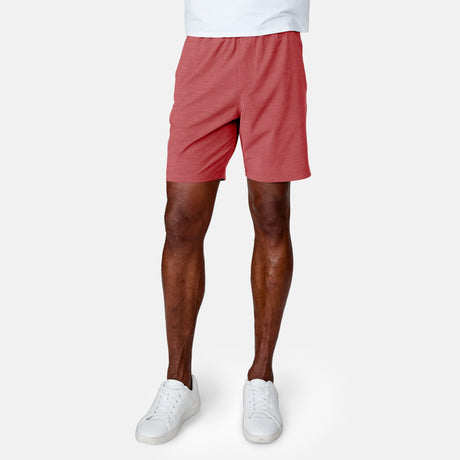 [Anderson is 6'2" wearing a size Medium.]  Man wearing the Free Country Men's Boardwalk Woven Pull-On Trek Short in Red, size M, made from lightweight breathable polyester fabric and featuring an elastic waistband and slanted pockets, styled with a white t shirt #color_ red