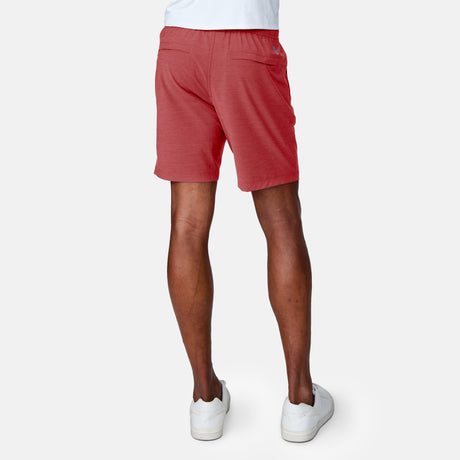 [Anderson is 6'2" wearing a size Medium.]  Man wearing the Free Country Men's Boardwalk Woven Pull-On Trek Short in Red, size M, made from lightweight breathable polyester fabric and featuring an elastic waistband and slanted pockets, styled with a white t shirt #color_ red