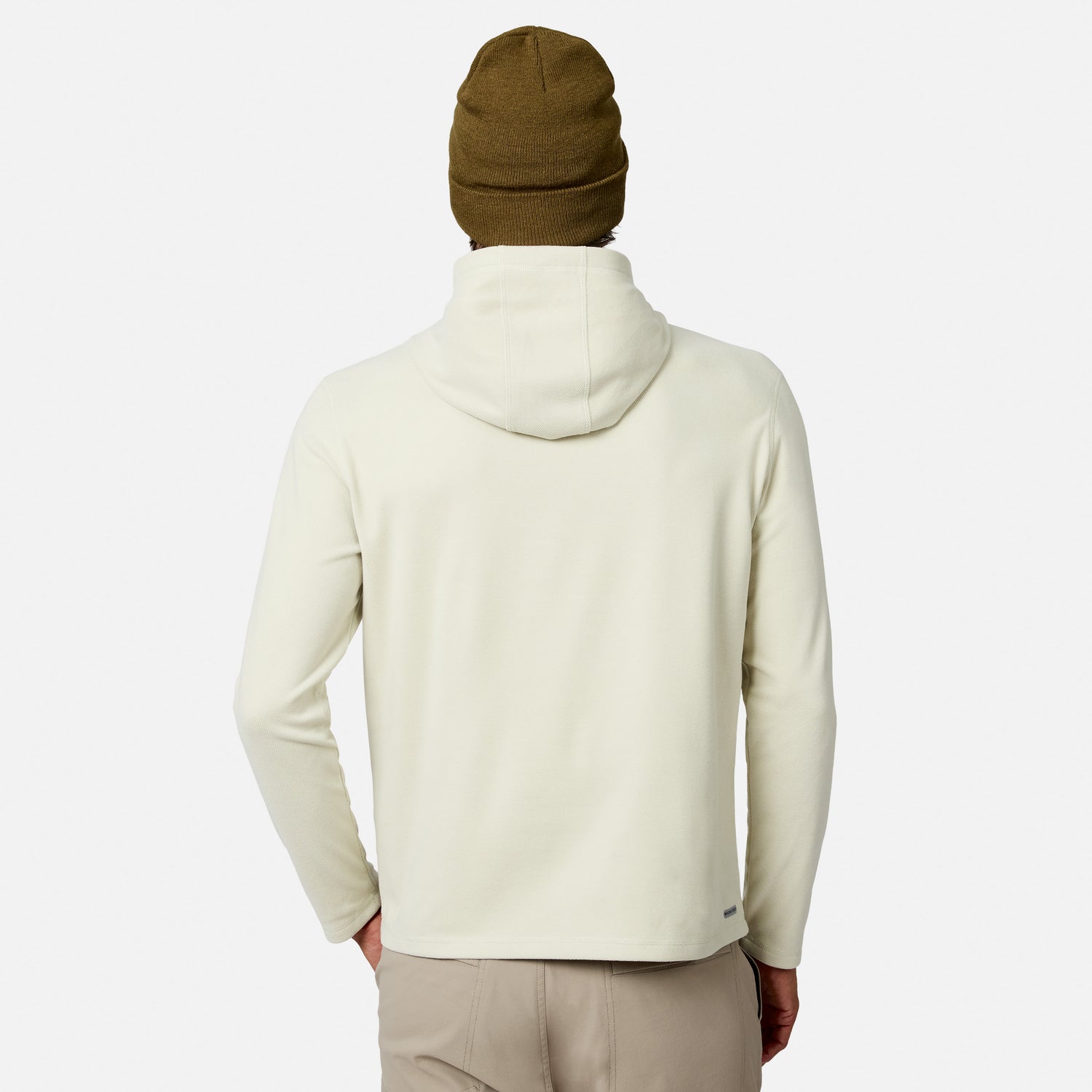 [Model is wearing size M.] A person shown from the back wearing a light cream hooded sweatshirt, a brown knit beanie, and beige pants against a plain light gray studio background.