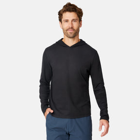 [Matt is 6'2" wearing size M.] Free Country men’s dark-colored hooded long-sleeve shirt with relaxed fit—styled with blue pants against a plain white background for a casual, comfort-forward look.