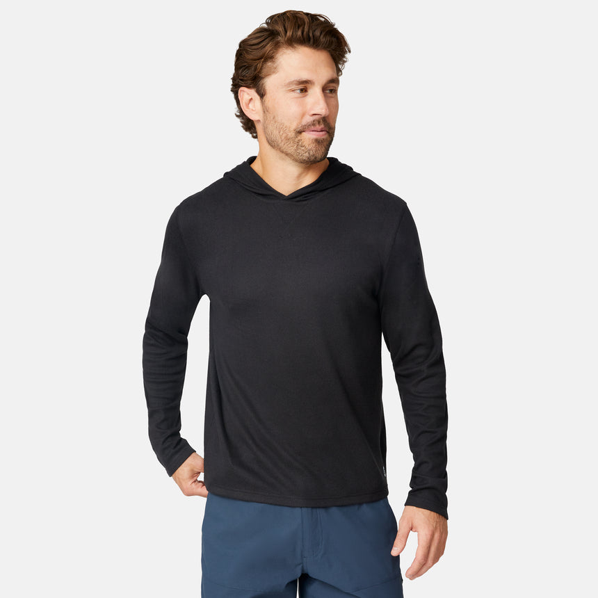 [Matt is 6'2" wearing size M.] Free Country men’s dark-colored hooded long-sleeve shirt with relaxed fit—styled with blue pants against a plain white background for a casual, comfort-forward look.